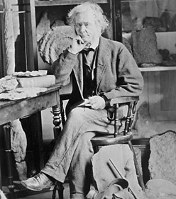 William Logan, assis  son bureau, entour de livres et de spcimens, 1865 