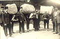 Turks carrying heavy bales of rugs, ca 
1930s.