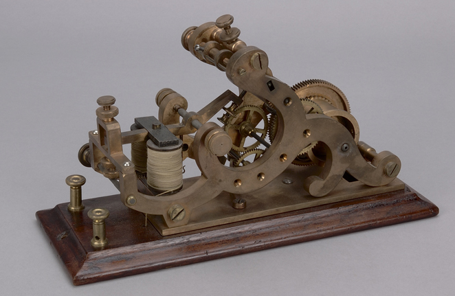 A model of a mechanical clock on a wooden base displayed at the Canadian Museum of History in Ottawa.